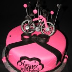 Pink and black themed bicycle cake