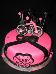 Pink and black themed bicycle cake