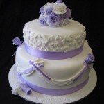 Purple and white drapes and roses engagement cake