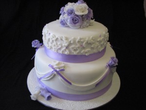 Purple and white drapes and roses engagement cake